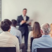 Business people attending a seminar.