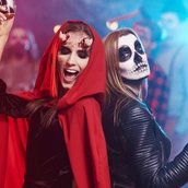 Women in creepy costumes dancing at Halloween party