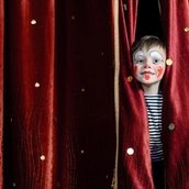 Boy Clown Peering Through Stage Curtains
