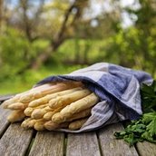 White asparagus on a wooden table outdoors in the garden