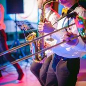 Midsection Of Men Playing Trumpet