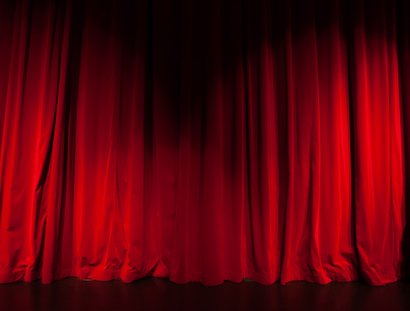 Curtain from the theatre with a spotlight as background