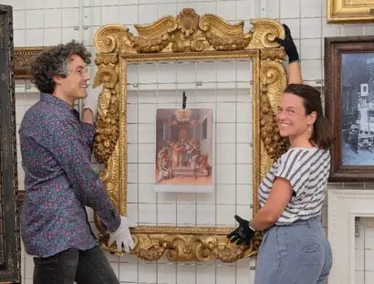 Blick in das Rahmenrestaurierungsatelier. Bertram Lorenz (li.) und Nadin Radecke (re.) stehen vor dem Sansovino-Rahmen.