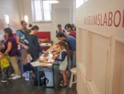Der Blick ins Museumslabor zeigt eine Gruppe beim gestalten kreativer Drucke