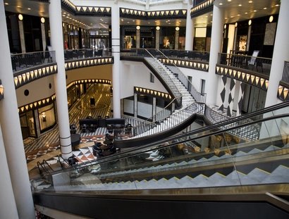 Atrium of a mall with multiple stairs and escalators