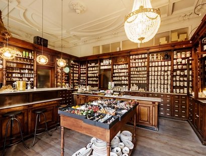 Interior Kühn Ceramics Shop wooden shelves with crockery and cups