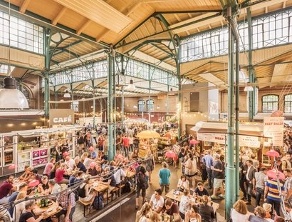 Visitors in the market hall Markthalle Neun in Berlin Kreuzberg