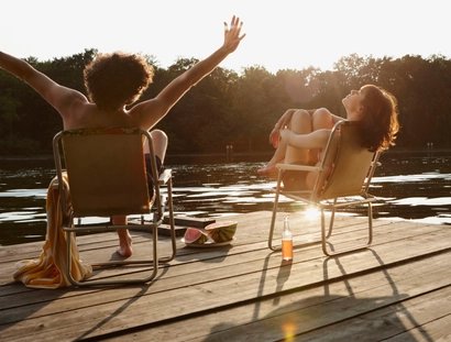 Germany, Berlin, Young couple relaxing on chairs