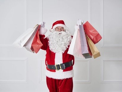Portrait of Santa claus holding shopping bags