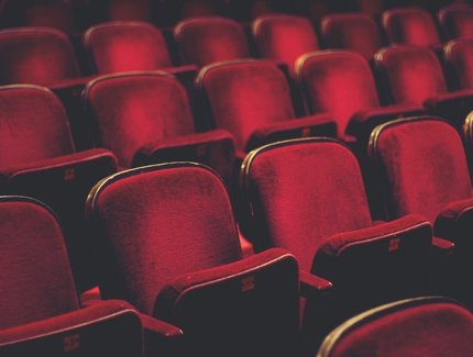 Empty comfortable red seats with numbers in cinema
