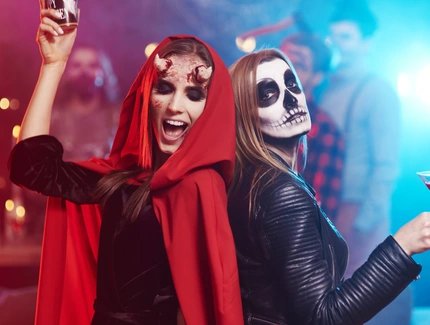 Women in creepy costumes dancing at Halloween party