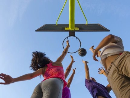 Group of Friends Jumping for a  Basketball