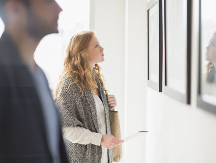 Woman admiring art in gallery