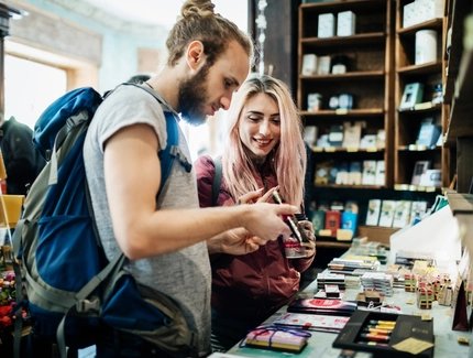Two Young Backpackers Exploring A Store Together
