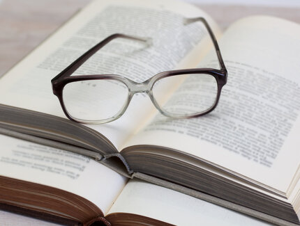 Glasses and open book on a table