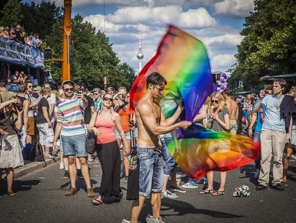 People with rainbow flags at the Pride Parade in Berlin