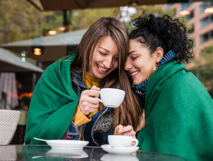 Ensemble sous une même couverture : des copines buvant un café à Berlin 