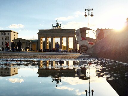 Brandenburg gate in Berlin: Reflection of the Brandenburg Gate in a puddle