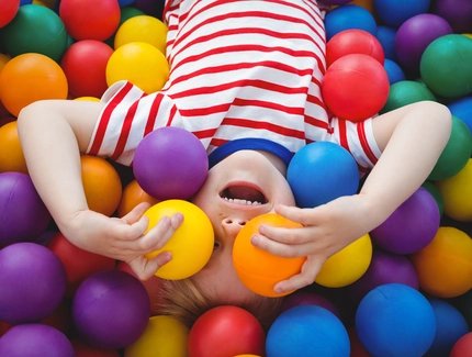 Cute smiling boy in sponge ball pool