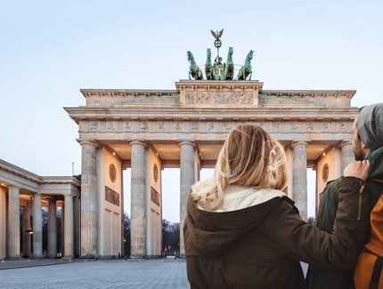 Young couple sightseeing at Brandenburg Gate in winter 