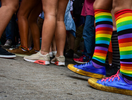 Person with rainbow socks in crowd in Berlin