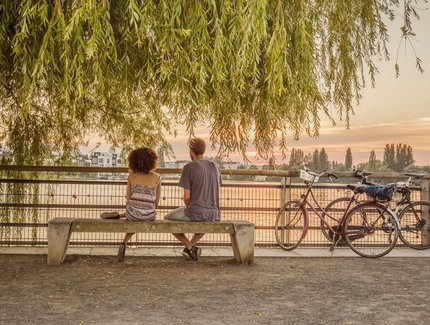 Romantic break of two cyclists at Lake Rummelsburg in Berlin