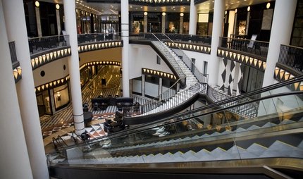 Atrium of a mall with multiple stairs and escalators
