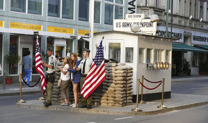 tourists taking pictures at Checkpoint Charlie in Berlin