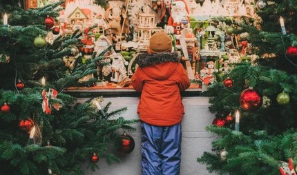 Little boy standing near Christmas tree in Rothenburg