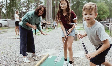 Family plays mini golf Miniature golf course