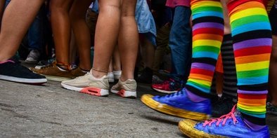 Person mit Regenbogensocken in Menschenmenge in Berlin
